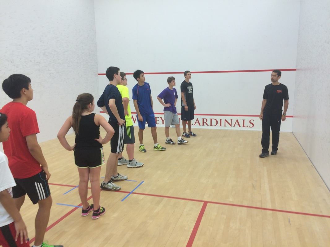 Shahier Razik coaches a squash camp on the squash sport court in DC