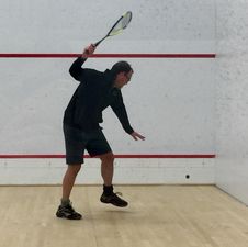 Photo of squash coach Ned Sparrow coaching juniors on the squash club in Baltimore