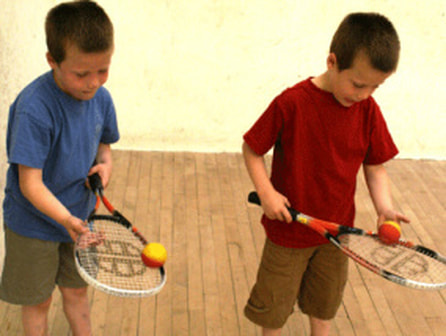 Image of two children during their mini squash lesson in DC