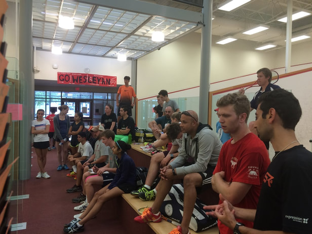 Players watch a tournament for the squash sport league in DC