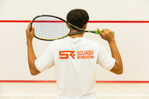 Photo of squash players watching a squash tournament at Squash Revolution